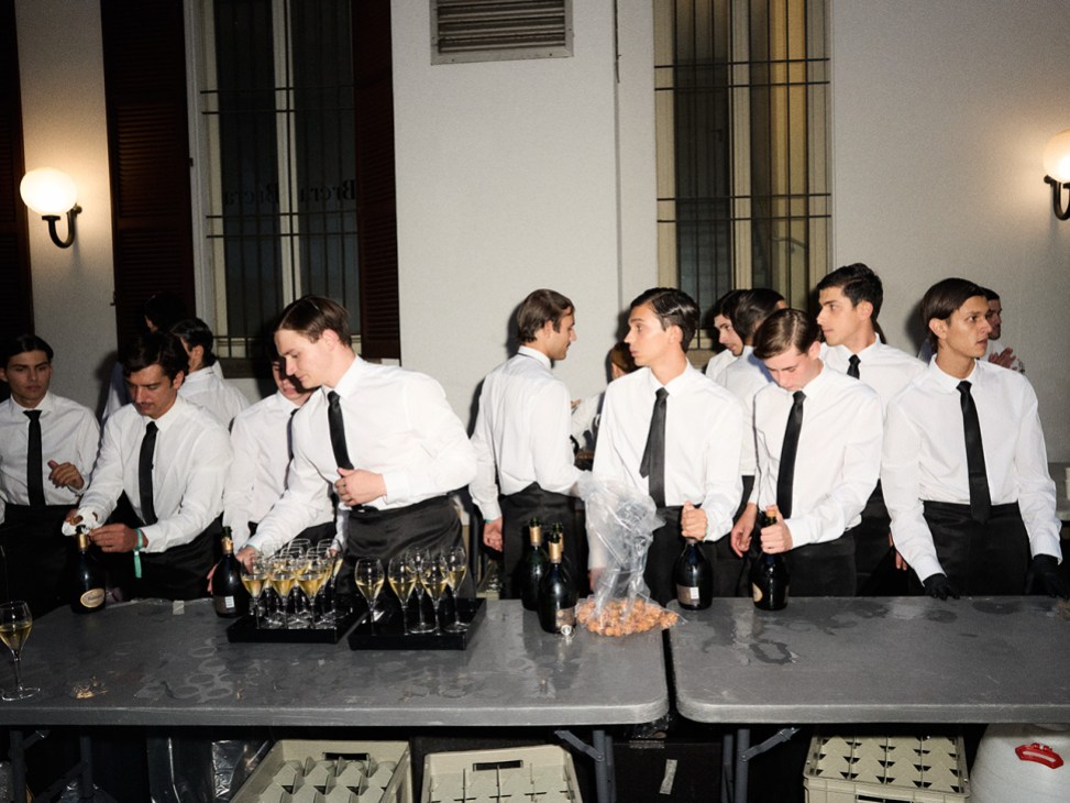 Waiters prepare a toast at Giorgio Armani’s farewell show at Milan Fashion Week