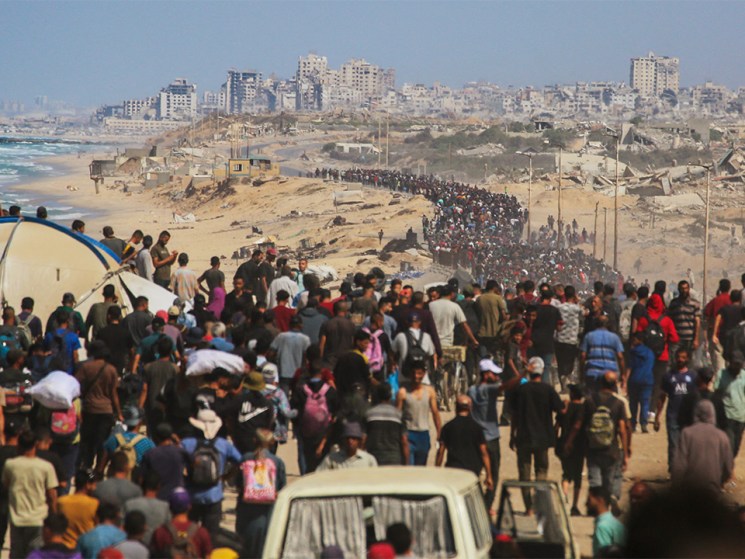 Palestinians walk along Al-Rashid road toward Gaza City from Nuseirat in the central Gaza Strip