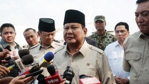 Indonesia's President Prabowo Subianto (C) speaks to media upon arrival from Egypt after attending the Gaza peace summit at Halim Perdanakusuma Air Force Base in Jakarta,
