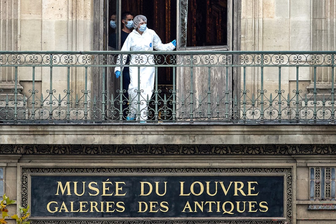 A crime scene investigator at the Louvre following the heist