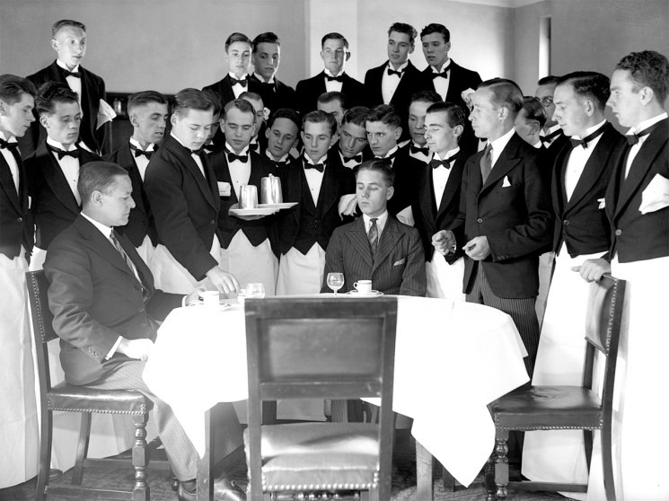Waiters crowding around a table