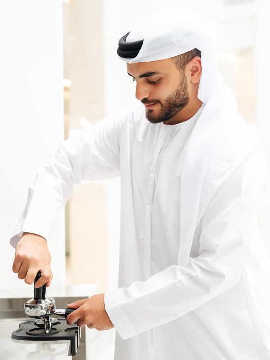 A barista learns the art of coffee at Les Roches Abu Dhabi