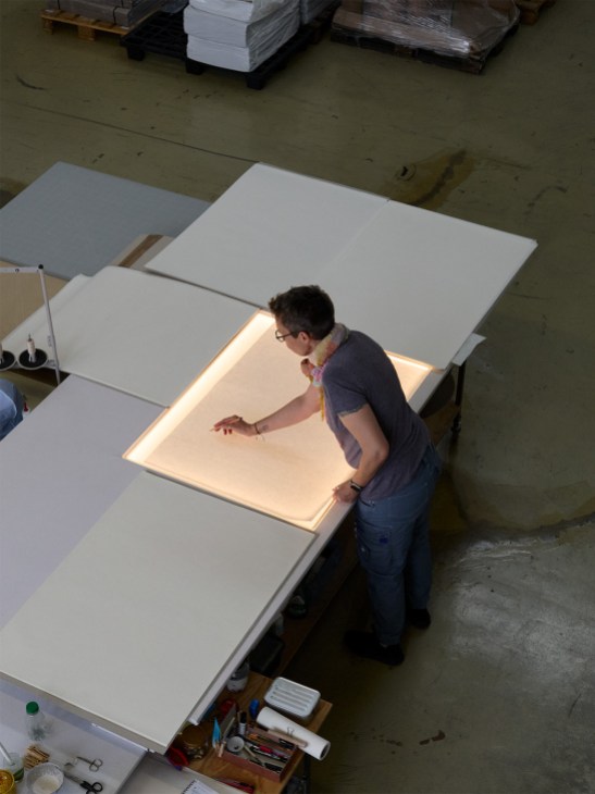Japanese paper is checked for flaws
before being cut and folded by hand at Ingo Maurer
