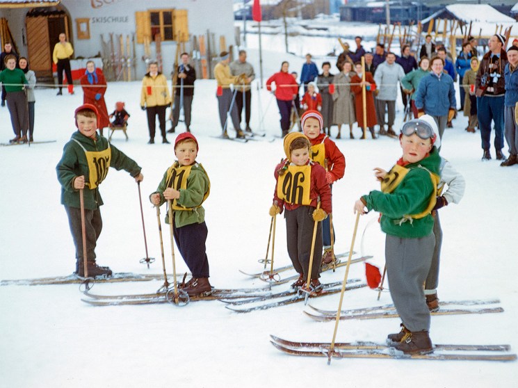 Young children skiing in historical image