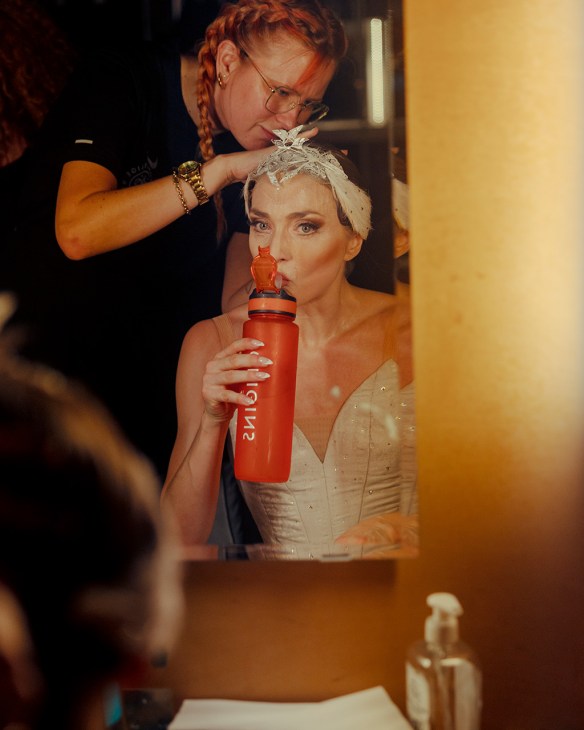 Lead dancer Astrid Elbo rehydrates backstage