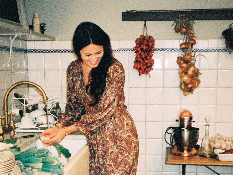 Mimi Thorisson in her kitchen looking at her dog