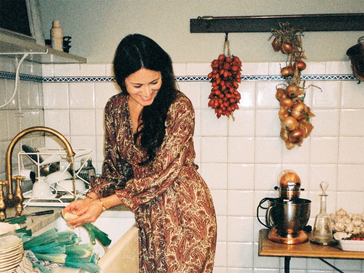 Mimi Thorisson in her kitchen looking at her dog