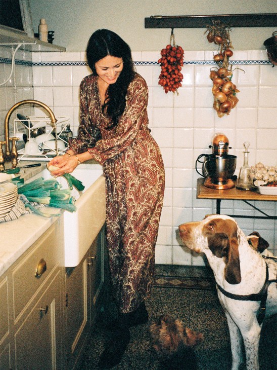 Mimi Thorisson in her kitchen looking at her dog