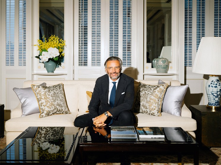 Benjamin Vuchot sits on a couch and smiles at the camera