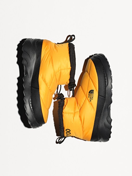 Yellow puffy boots by The North Face