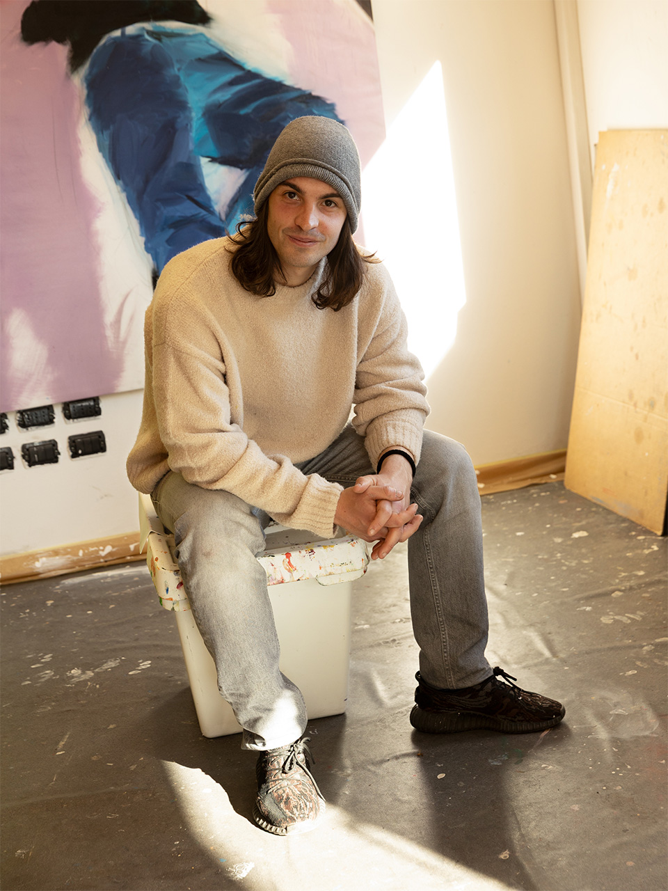 Andrea Fontanari sits in his studio, looks at camera