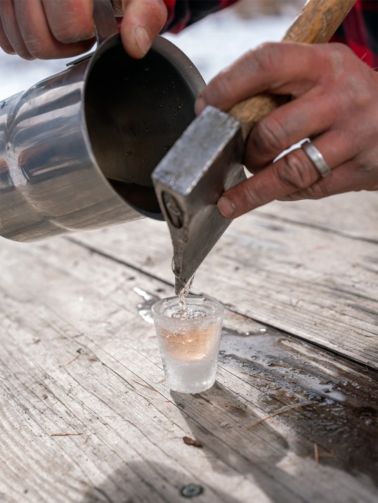 Preparing a shot in a glass made from ice