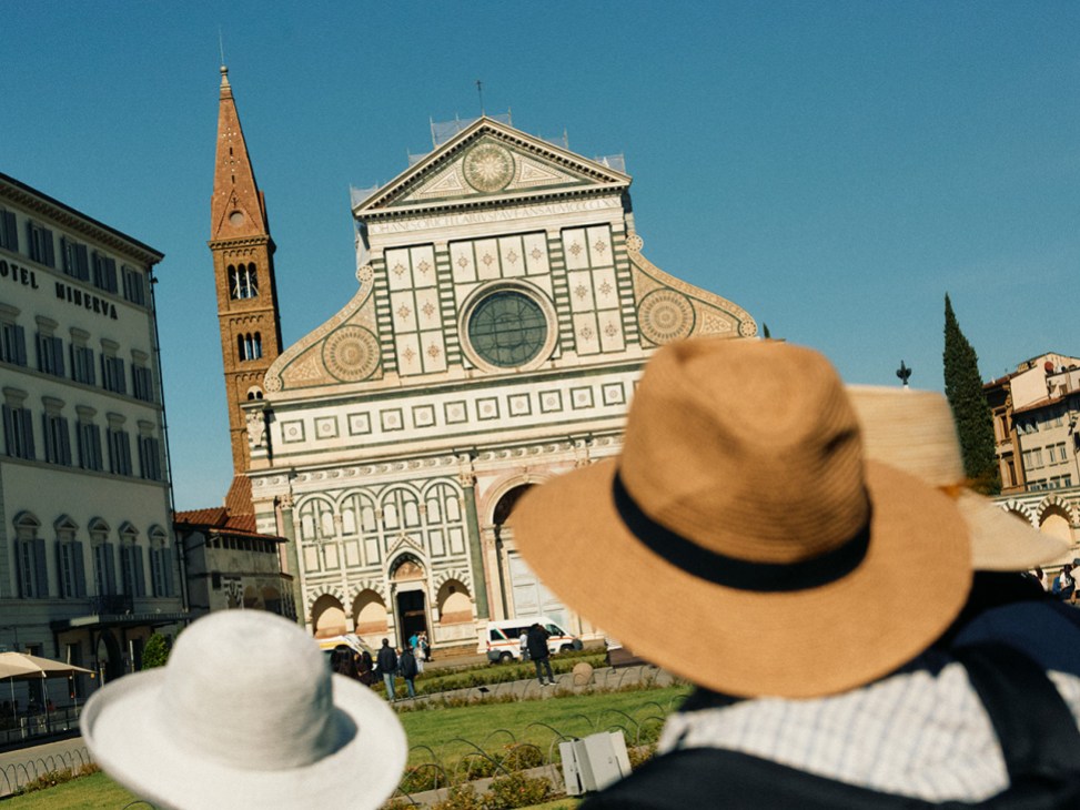 Tourists admire Santa Maria Novella in Florence