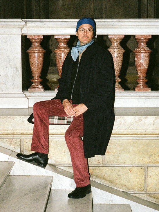 Young man walks up steps in stylish winter wear