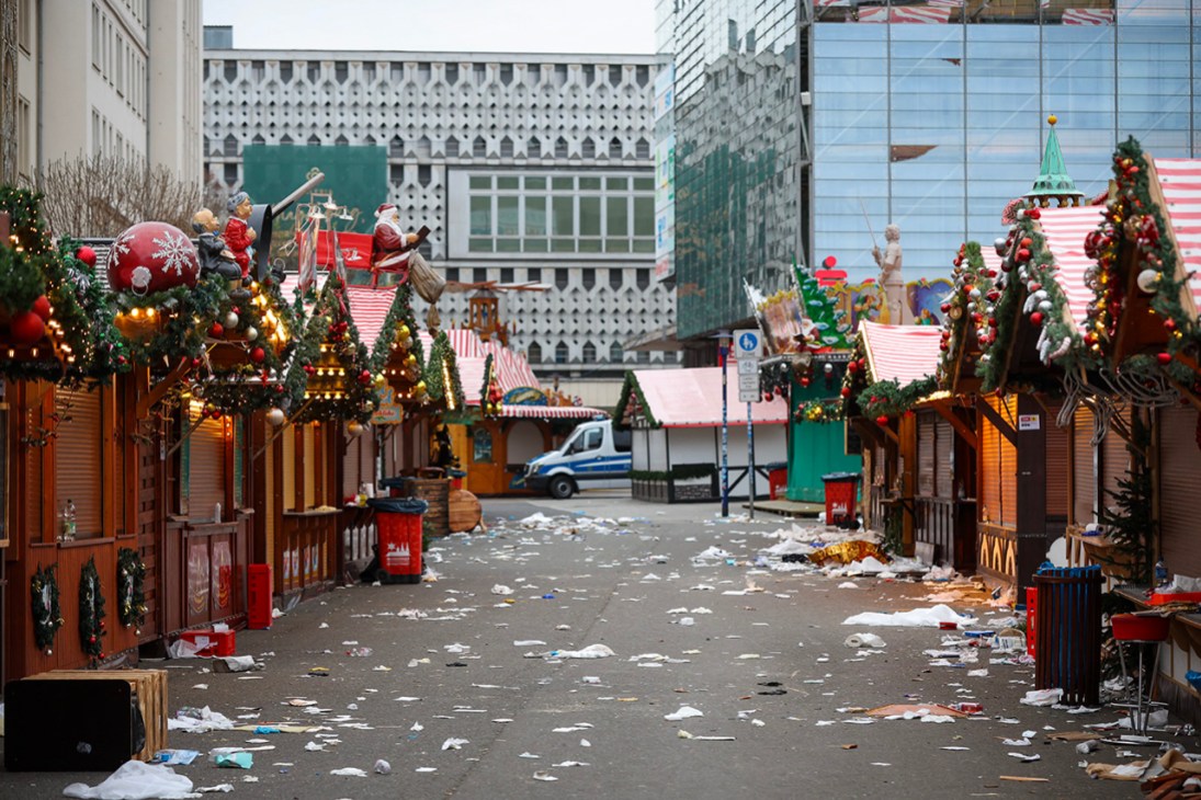 TOPSHOT - Debris a closed stalls are seen on the site of a car-ramming attack on a Christmas market in Magdeburg, eastern Germany, on December 21, 2024, resulting in several deaths and dozens of injured. German media reports that the death toll has risen to four over night and up to 200 injured in the attack on December 20th. (Photo by Ronny HARTMANN / AFP) (Photo by RONNY HARTMANN/AFP via Getty Images)