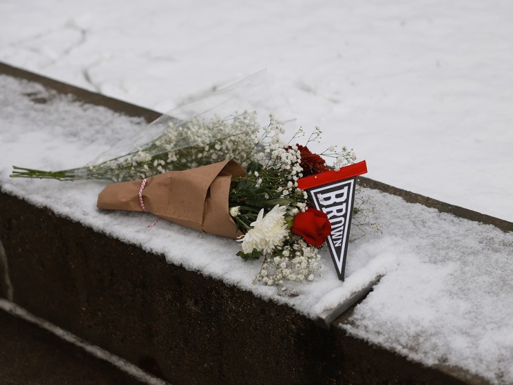PROVIDENCE, RHODE ISLAND - DECEMBER 14: A bouquet is left outside of the engineering and physics building at Brown University, the site of a mass shooting yesterday that left at least two people dead and nine others injured, on December 14, 2025, in Providence, Rhode Island. A suspect in the shooting was detained overnight at a hotel in a nearby community following a manhunt across the prestigious university and the greater Providence area. The shooting took place around 4 p.m. on Saturday as students were preparing for exams and the holiday break. (Photo by Spencer Platt/Getty Images)