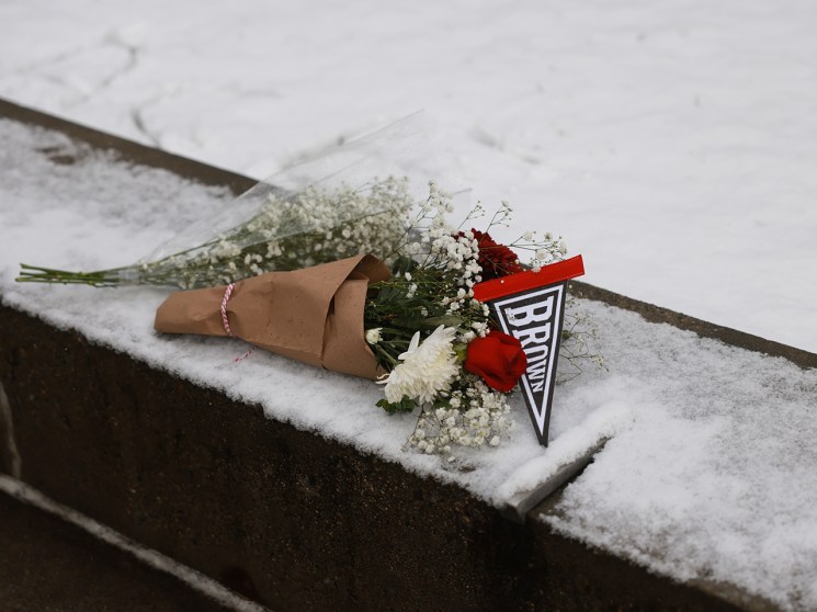 PROVIDENCE, RHODE ISLAND - DECEMBER 14: A bouquet is left outside of the engineering and physics building at Brown University, the site of a mass shooting yesterday that left at least two people dead and nine others injured, on December 14, 2025, in Providence, Rhode Island. A suspect in the shooting was detained overnight at a hotel in a nearby community following a manhunt across the prestigious university and the greater Providence area. The shooting took place around 4 p.m. on Saturday as students were preparing for exams and the holiday break. (Photo by Spencer Platt/Getty Images)