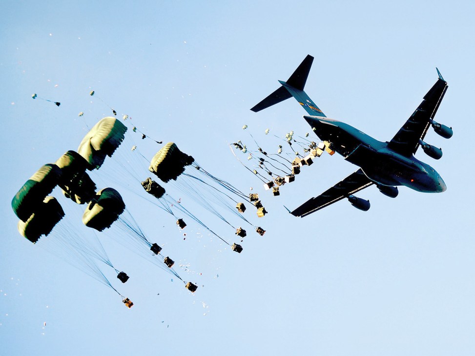 Planes in the sky dropping packages