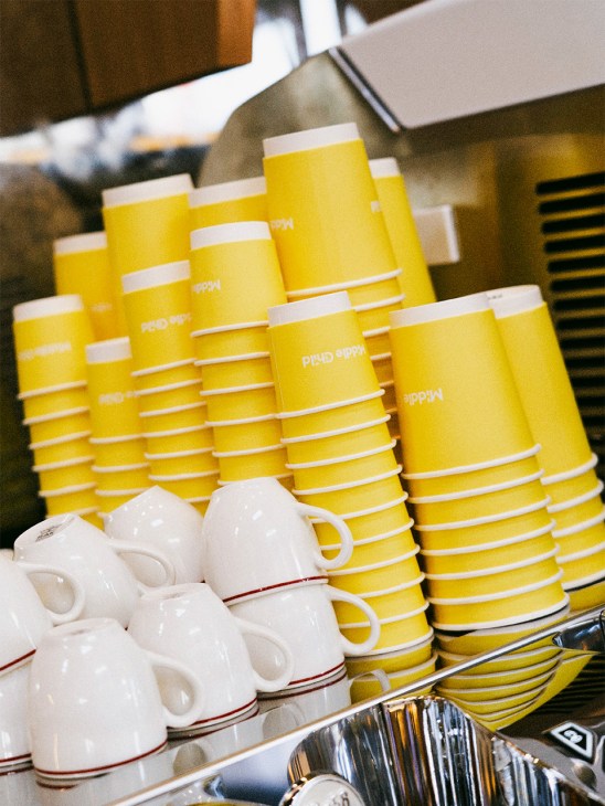 Coffee cups stacked on a coffee machine at Middle Child