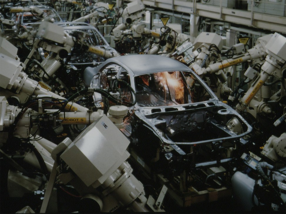 A car being built by robotics in a factory