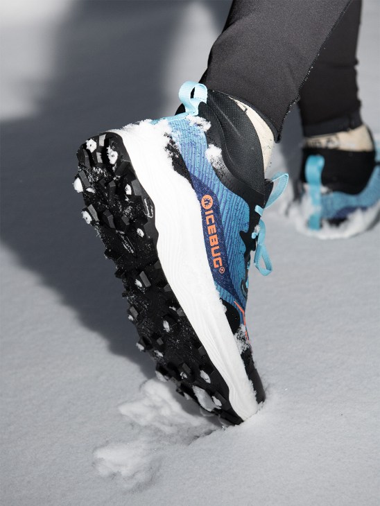 Person runs on snow in an icebug shoe
