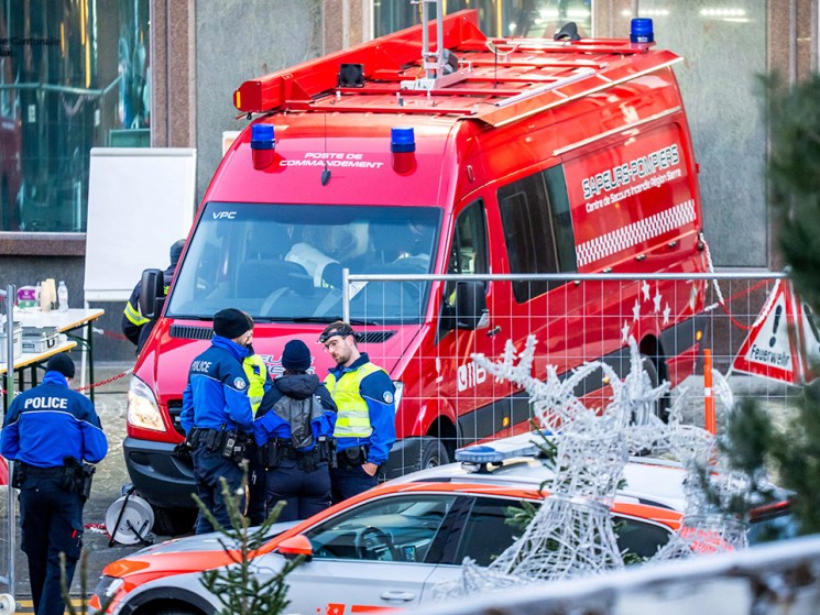 Police officers and rescuers stand next to a firefighters vehicle on the site of a fire that ripped through the bar Le Constellation in Crans-Montana on January 1, 2026. Several dozen people are presumed dead and around 100 injured after a fire ripped through a crowded bar in the luxury Swiss ski resort of Crans-Montana, Swiss police said on January 1, 2026. Police, firefighters and rescuers rushed to the popular resort, which is set to host the Ski World Cup from January 30, after the fire broke out in the early hours of New Year's Day. (Photo by MAXIME SCHMID / AFP via Getty Images)