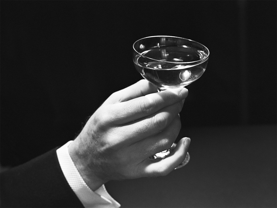 martini glass in a hand, black and white