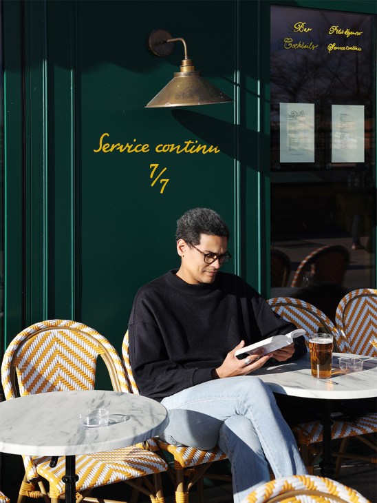 Man reading a book outside the deux Gares Express