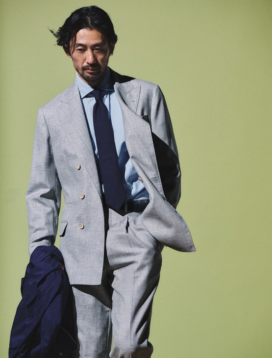 Model wearing jacket, shirt, trousers, tie and jacket (in hand) by Brunello Cucinelli, belt by Polo Ralph Lauren