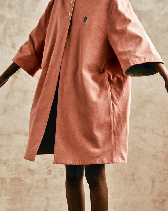 Model wearing peach-coloured Prada dress