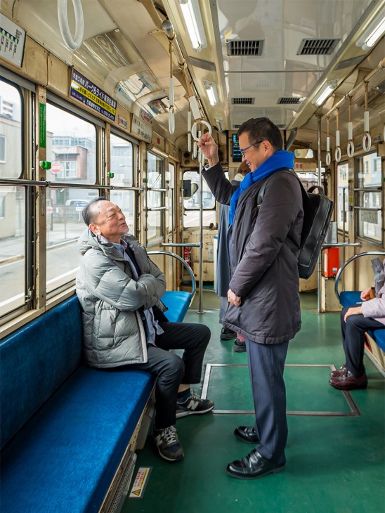 Mayor of Takaoka, Yuzuru Demachi on the tram