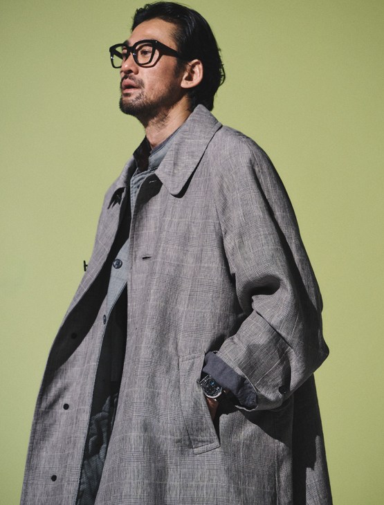 Model wearing coat by Kaptain Sunshine, long shirt by Engineered Garments, shirt by Tender Co. from Maidens Shop, glasses by Mykita, Lange 1 perpetual calendar watch by A. Lange & Söhne