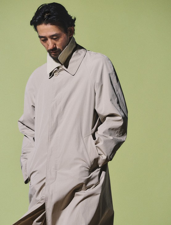 Model wearing coat and jacket by Prada