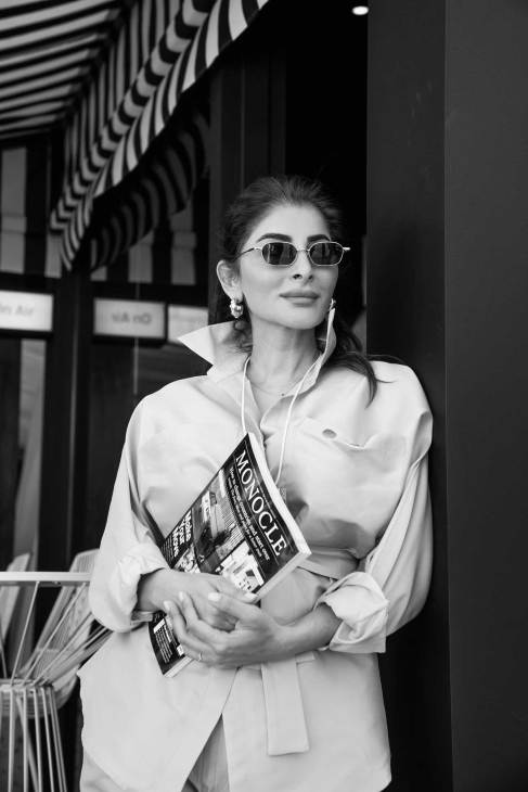 Participant of the World Governments Summit holding a magazine