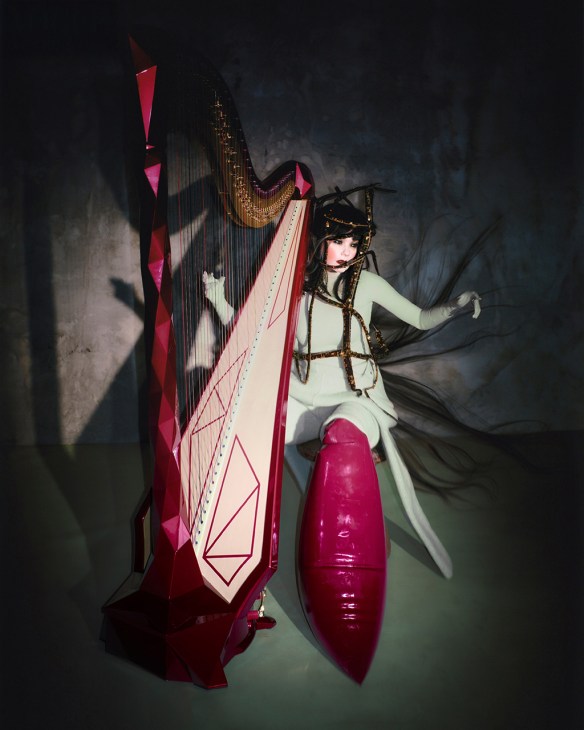 Björk performing with a large harp