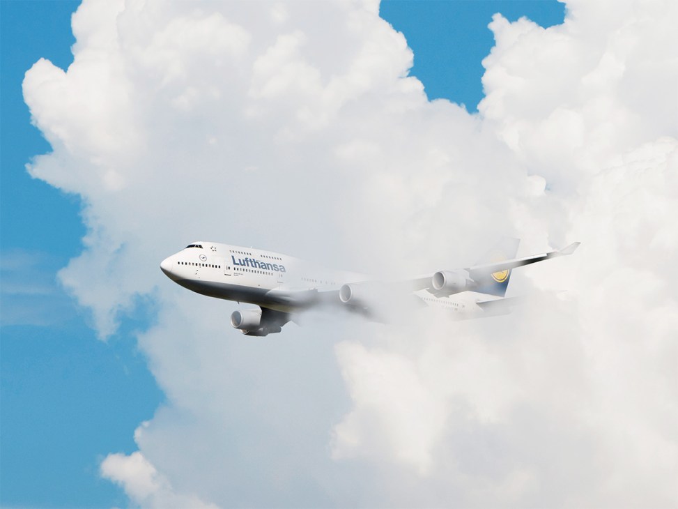 A Lufthansa Boeing 747 flying through clouds 