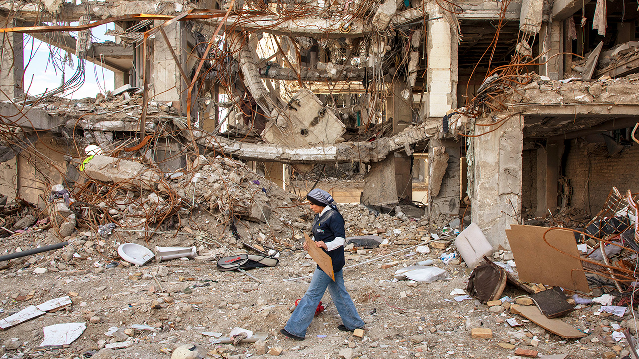 A woman walks among buildings destroyed in a joint attack by Israel and the United States on April 6, 2026, in Tehran, Iran. The United States and Israel continue their joint attack on Iran that began on February 28.