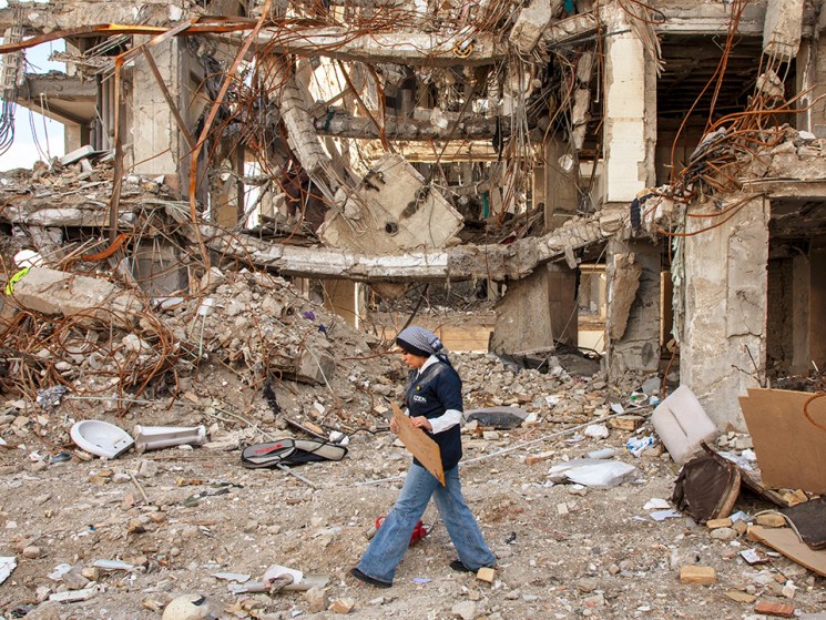 A woman walks among buildings destroyed in a joint attack by Israel and the United States on April 6, 2026, in Tehran, Iran. The United States and Israel continue their joint attack on Iran that began on February 28.