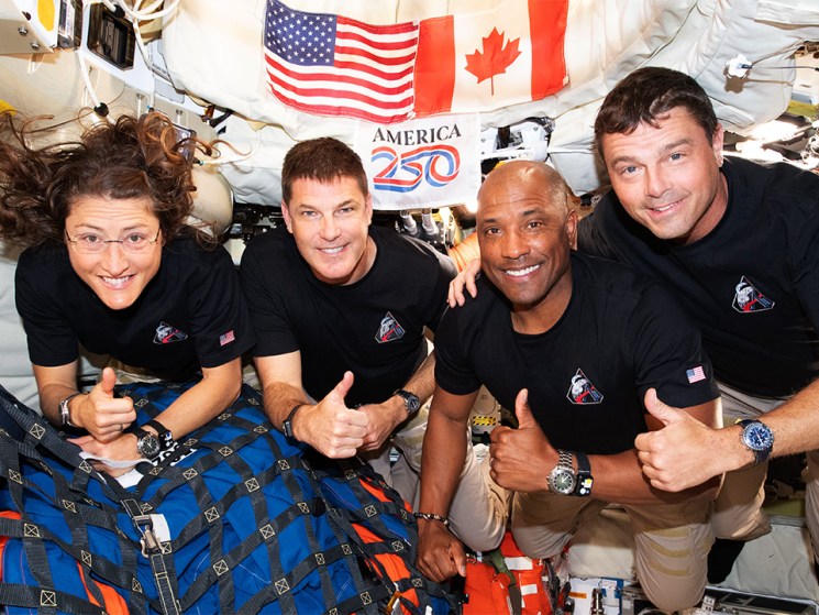 Mission Specialist Christina Koch, Mission Specialist Jeremy Hansen, Pilot Victor Glover, and Commander Reid Wiseman – pause for a group photo inside the Orion spacecraft on their way home. Following a swing around the far side of the Moon on April 6, 2026, the crew exited the lunar sphere of influence