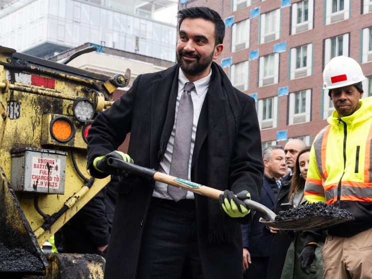 Zohran Mamdani, mayor of New York, uses a spade to fill a hole during a news conference with New York Department of Transportation (DOT) workers in New York, US, on Tuesday, Jan. 6, 2026. The New York Department of Transportation (DOT) is working to redesign the "Williamsburg Bridge bump," two inch high steel plates that cover the expansion joints on the bridge's pedestrian and bike path which have caused numerous cyclist crashes, complaints, and lawsuits. Photographer: Adam Gray/Bloomberg via Getty Images