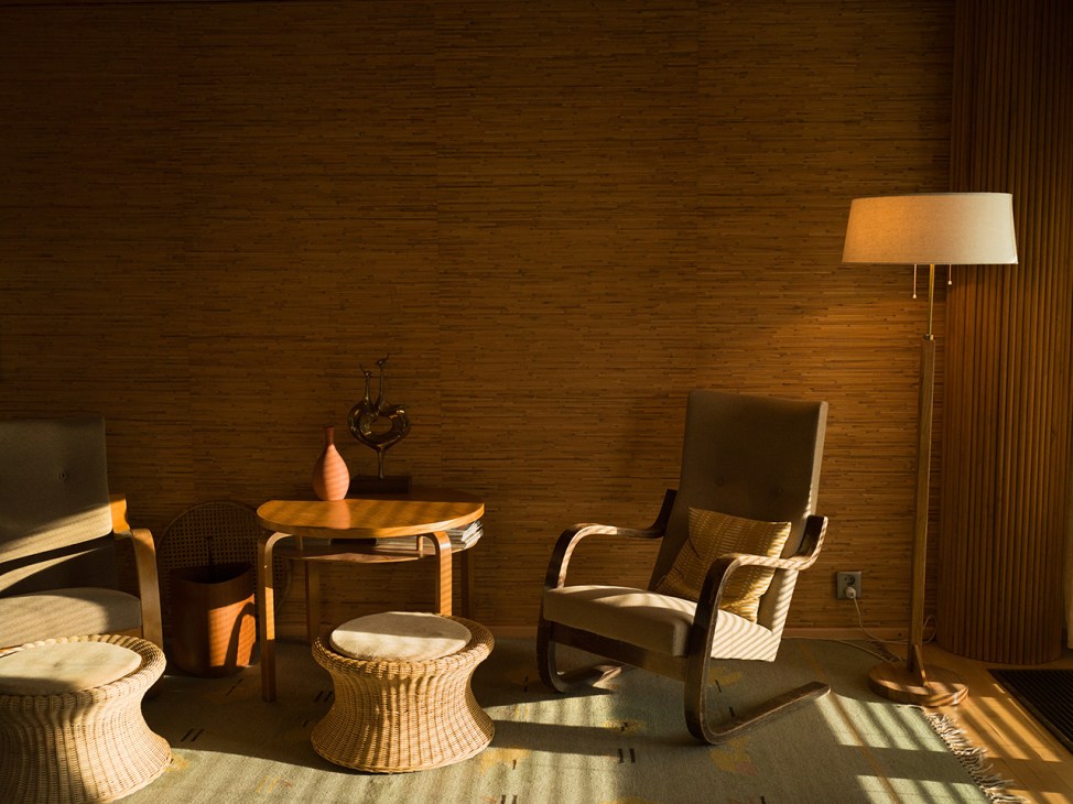 The Armchair 35, A72 club table, Armchair 36, Floor Lamp 806A and  Eero Aarnio mushroom stools in rattan - all Alvar Aalto
