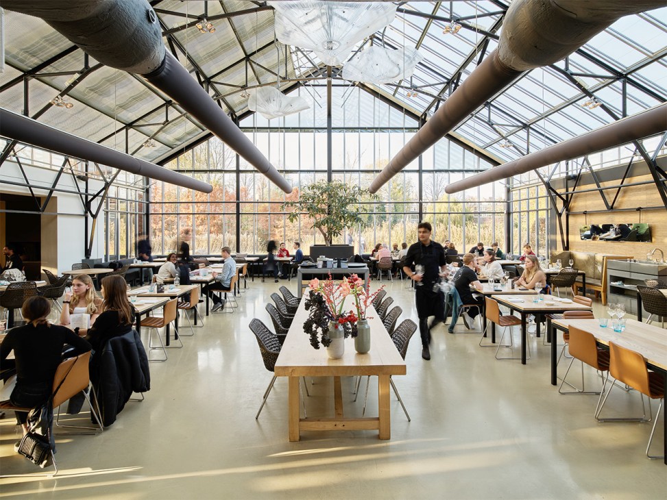 Inside De Das restaurant with glass roof in Amsterdam