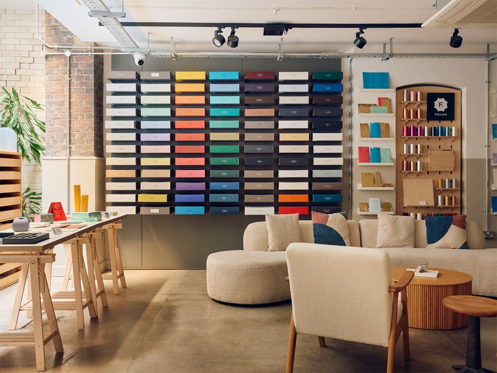 Interior of Mount Street Printers showroom displaying colorful paper samples organized in wall-mounted shelving units.