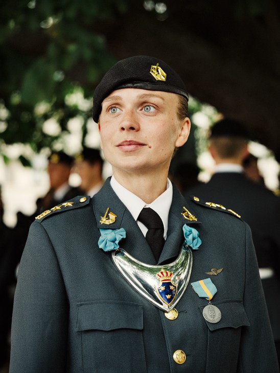 Swedish Army Band member in formal green military uniform with medals and decorations.