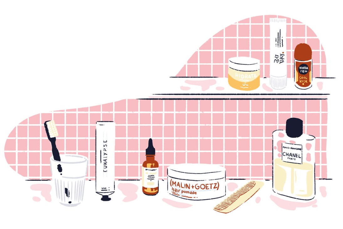 Illustration of skincare and fragrance products including Chanel perfume, Nivea deodorant, MALIN+GOETZ hair pomade, and other grooming items arranged on a pink tiled bathroom shelf.