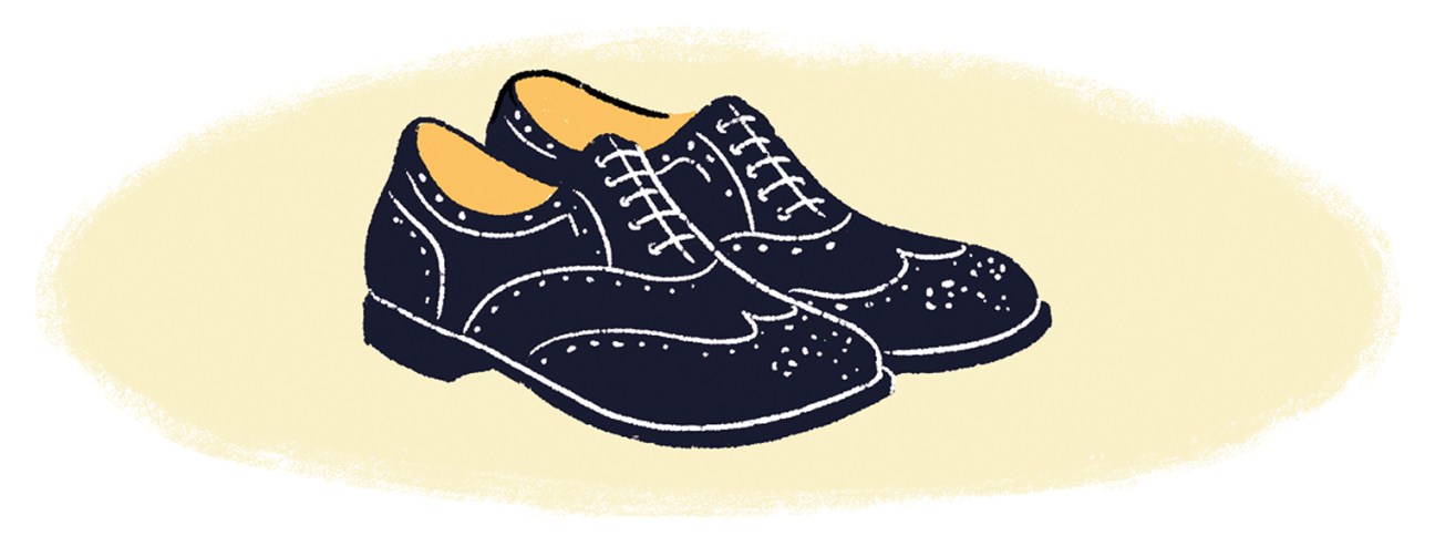 Illustration of a pair of black oxford shoes with white stitching and tan leather lining.