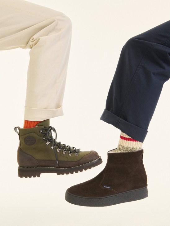 Two people wearing cuffed trousers and patterned socks with Church's Shefford boots in forest green and brown suede.