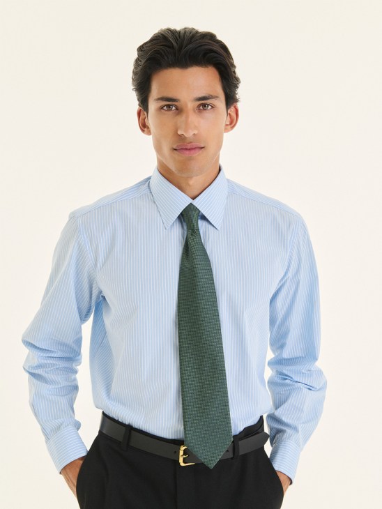 Man wearing light blue pinstriped shirt and green tie by Charvet