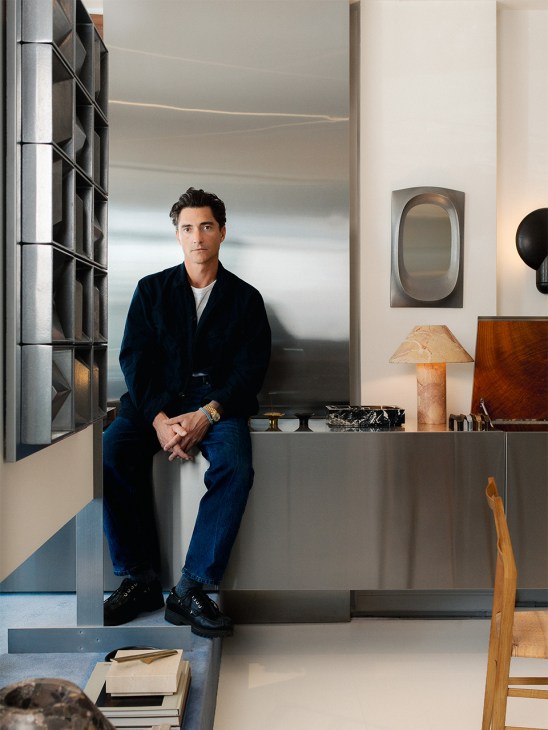 Australian industrial designer Henry Wilson seated in his Paddington studio among contemporary furniture and design objects.