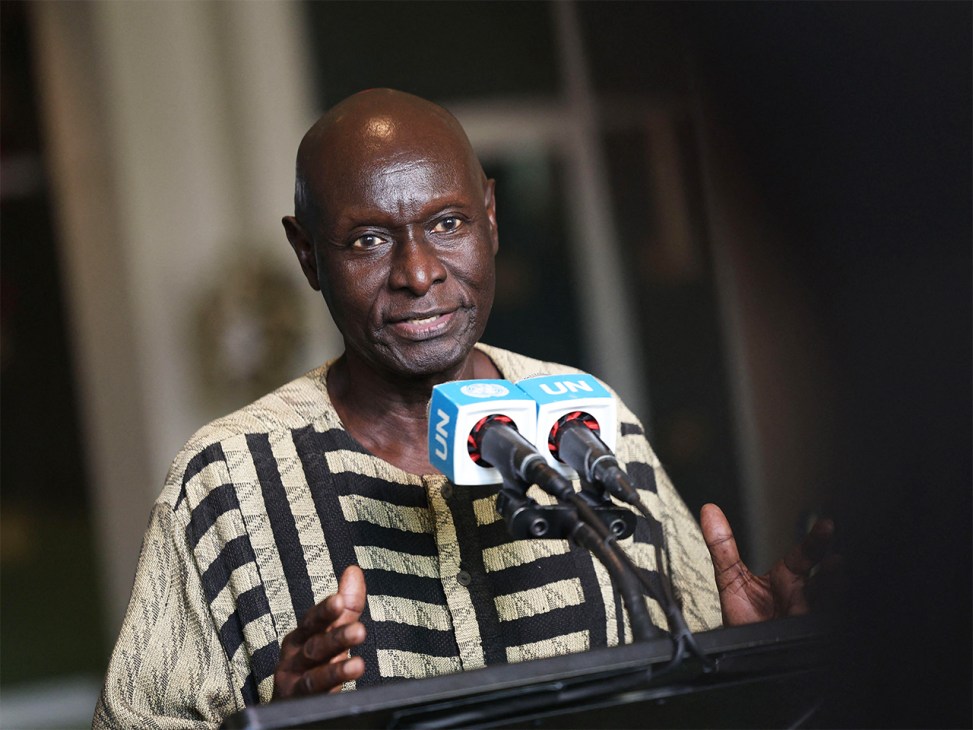 Olara Otunnu speaking at a podium with UN microphones during a press conference.
